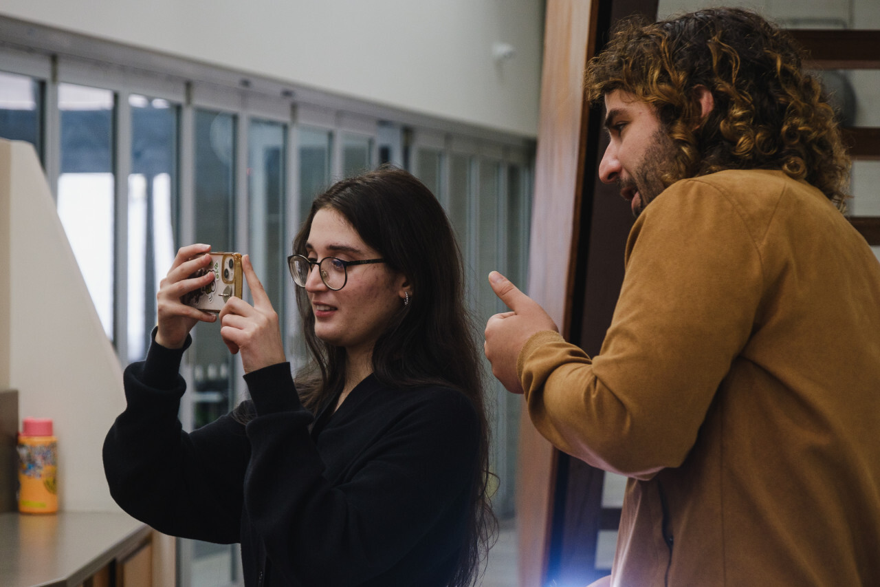 Girl with phone camera learning to shoot video